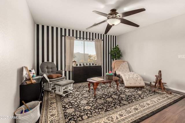 sitting room featuring hardwood / wood-style floors and ceiling fan