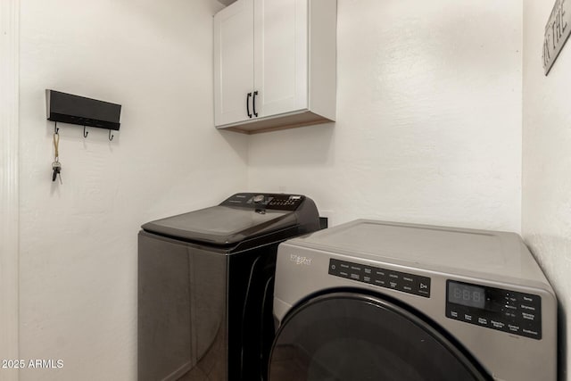 laundry area featuring cabinets and washer and dryer