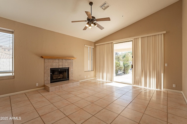 unfurnished living room featuring lofted ceiling, ceiling fan, light tile patterned floors, and a tiled fireplace