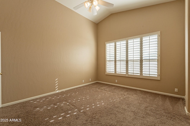 carpeted spare room with ceiling fan and vaulted ceiling