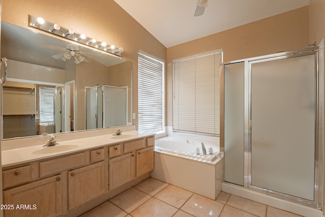 bathroom with vanity, vaulted ceiling, ceiling fan, tile patterned flooring, and shower with separate bathtub