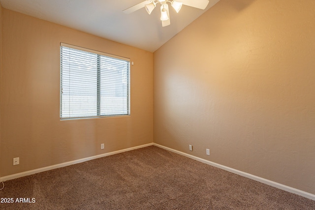 spare room featuring carpet floors, vaulted ceiling, and ceiling fan