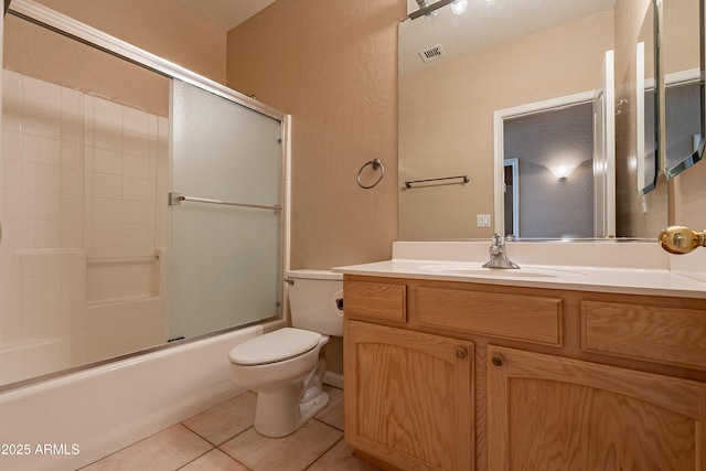 full bathroom with toilet, tile patterned flooring, vanity, and combined bath / shower with glass door