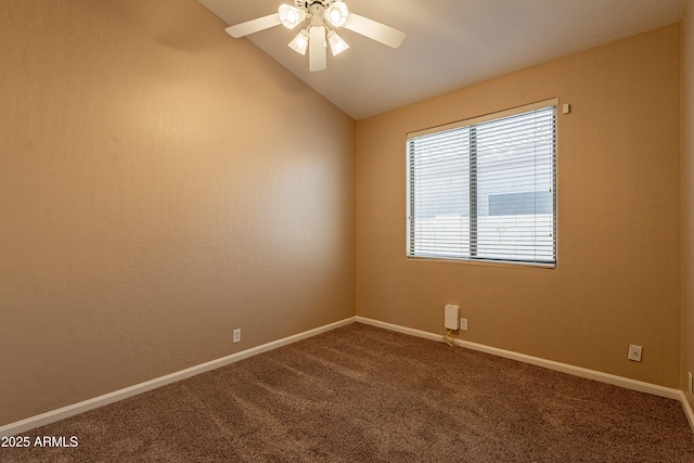 carpeted spare room featuring vaulted ceiling and ceiling fan