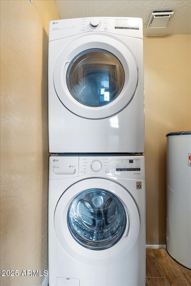 839 S Westwood Unit 154, Mesa, AZ 85210 - washroom with stacked washer / dryer, gas water heater, and wood finished floors