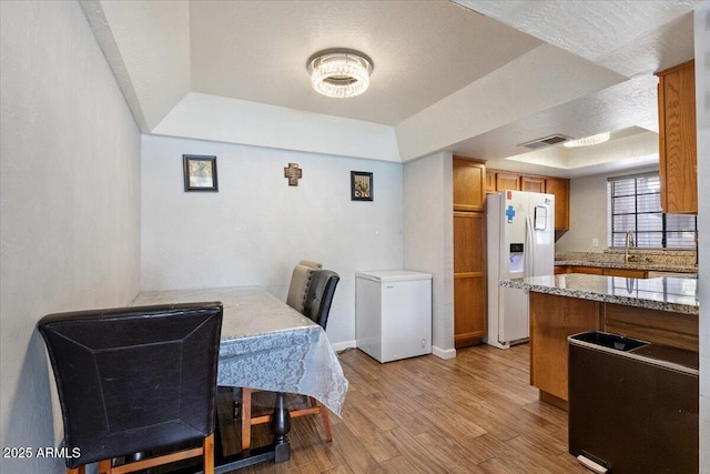 839 S Westwood Unit 154, Mesa, AZ 85210 - dining room with a tray ceiling, light wood-style flooring, and baseboards