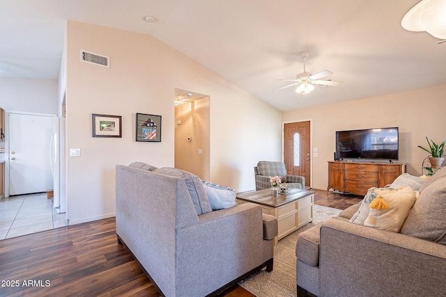 living room featuring ceiling fan, dark hardwood / wood-style flooring, and vaulted ceiling