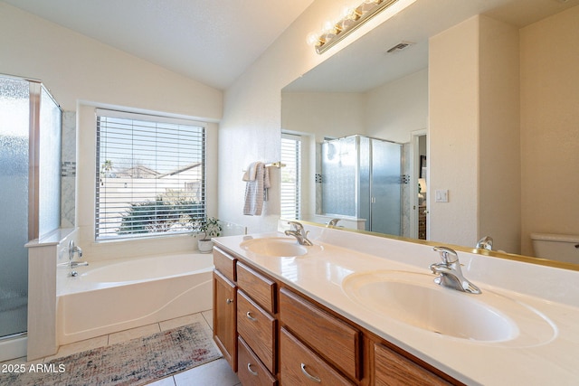 full bathroom featuring toilet, vanity, vaulted ceiling, tile patterned floors, and shower with separate bathtub