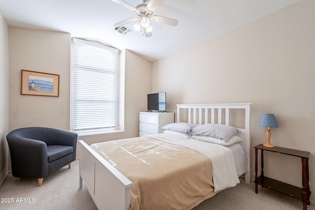 carpeted bedroom with vaulted ceiling and ceiling fan