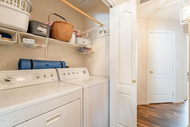 clothes washing area featuring separate washer and dryer and dark hardwood / wood-style flooring