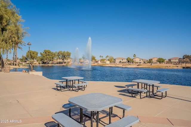 view of swimming pool featuring a water view