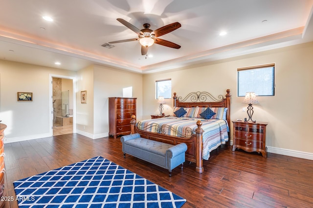 bedroom featuring ceiling fan, dark hardwood / wood-style flooring, and a raised ceiling