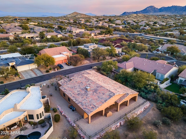 aerial view at dusk featuring a mountain view