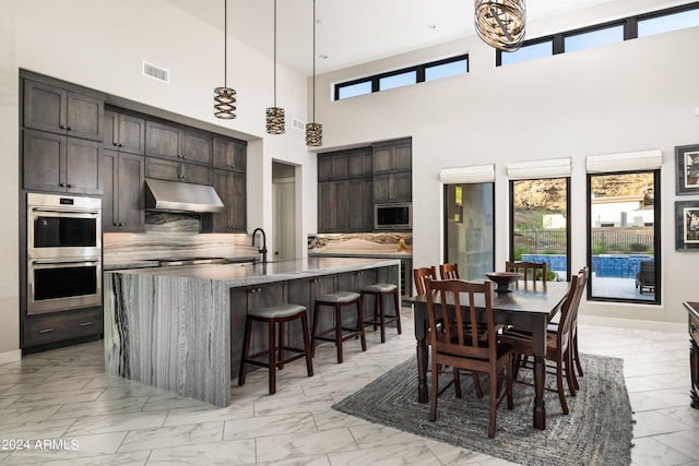 dining area with marble finish floor, baseboards, and visible vents