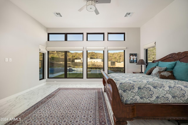 bedroom featuring marble finish floor, baseboards, visible vents, and ceiling fan