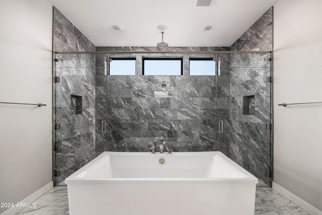 bathroom with marble finish floor, a stall shower, and baseboards