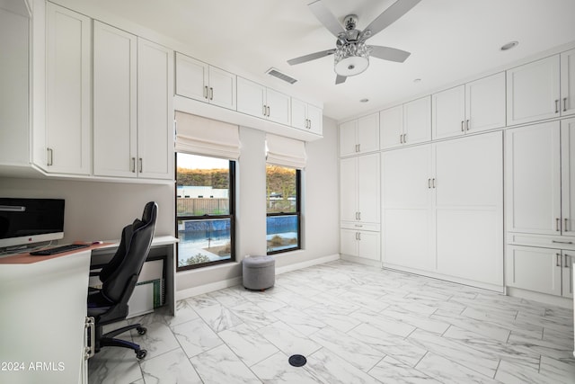 home office featuring a ceiling fan, marble finish floor, visible vents, and baseboards