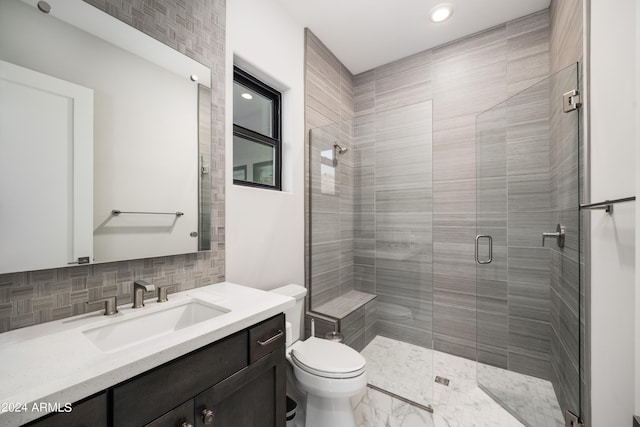 full bath with tasteful backsplash, a stall shower, vanity, and toilet