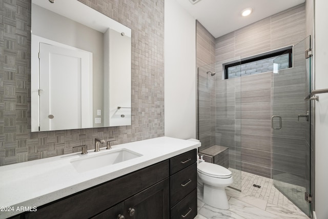 full bath with marble finish floor, backsplash, toilet, a shower stall, and vanity