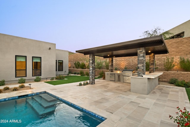 view of patio featuring an outdoor pool, an outdoor kitchen, a grill, and fence