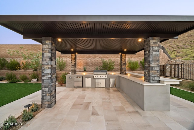 view of patio with area for grilling and a grill