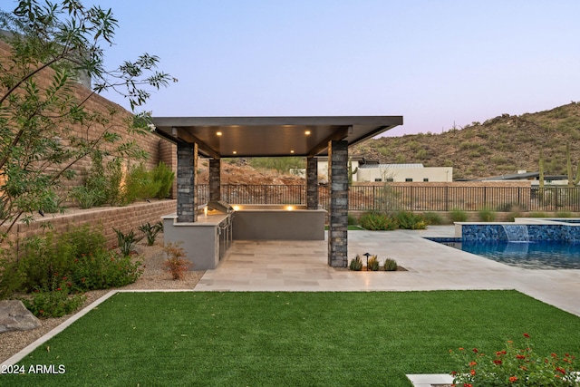 exterior space featuring a yard, a fenced in pool, fence, and area for grilling