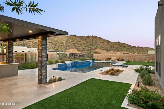 view of swimming pool featuring a fenced in pool, a patio area, a fenced backyard, and a mountain view