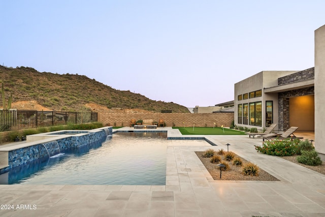 view of pool featuring a fenced backyard, a patio, a fenced in pool, and an in ground hot tub