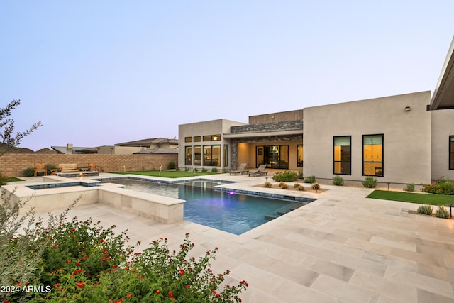 view of swimming pool with a patio area, a fenced backyard, a fenced in pool, and an in ground hot tub