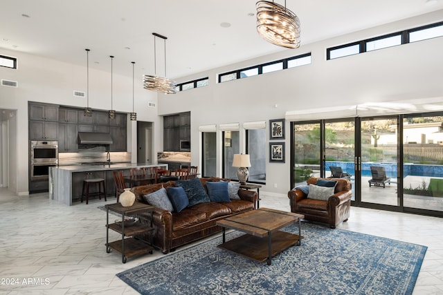 living area with marble finish floor, french doors, visible vents, and baseboards