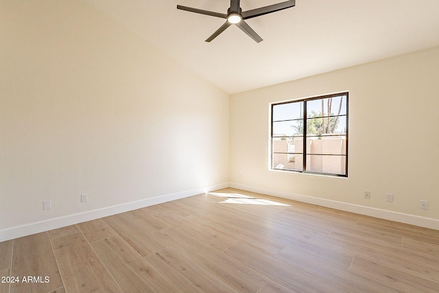 unfurnished room with light wood-style floors, ceiling fan, vaulted ceiling, and baseboards