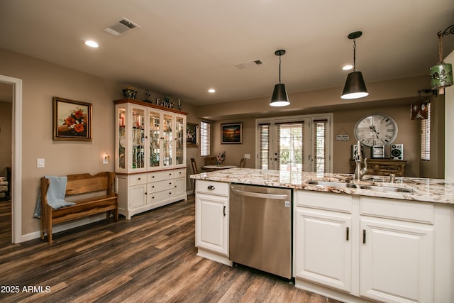 kitchen featuring sink, white cabinetry, dark hardwood / wood-style floors, light stone countertops, and stainless steel dishwasher