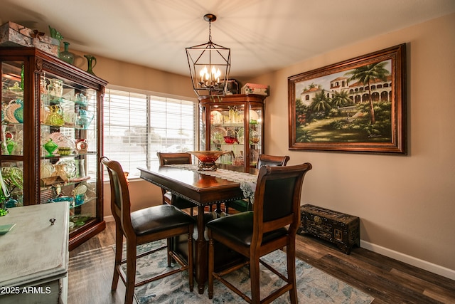 dining room featuring an inviting chandelier and dark wood-type flooring