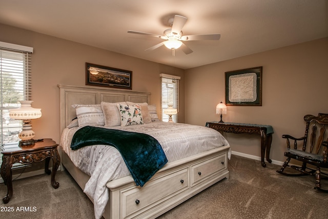 bedroom featuring multiple windows, dark carpet, and ceiling fan