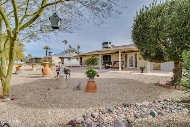 rear view of house with a patio, central air condition unit, and french doors