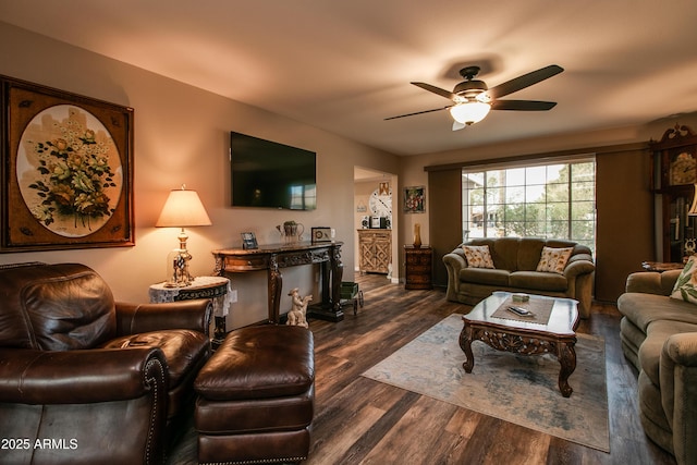 living room featuring dark hardwood / wood-style floors and ceiling fan