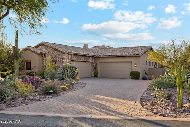 7846 E Wilderness Trl, Gold Canyon, AZ 85118 - view of front of home with an attached garage, stucco siding, decorative driveway, and a tiled roof