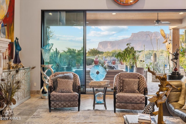 7846 E Wilderness Trl, Gold Canyon, AZ 85118 - living area featuring a mountain view, a ceiling fan, and baseboards