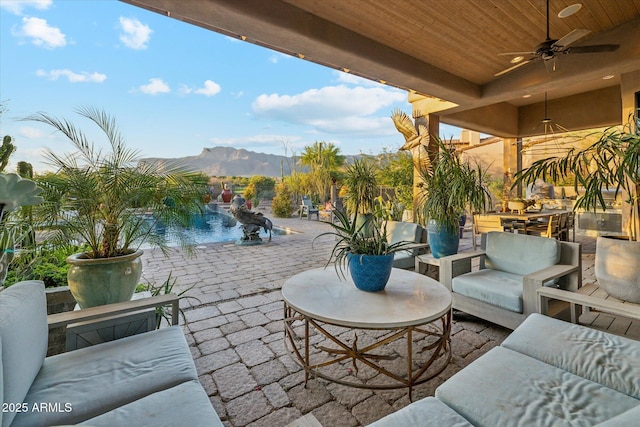 7846 E Wilderness Trl, Gold Canyon, AZ 85118 - view of patio featuring an outdoor hangout area, a ceiling fan, a mountain view, and an outdoor pool