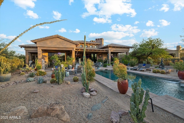 7846 E Wilderness Trl, Gold Canyon, AZ 85118 - back of house featuring a patio, an outdoor pool, and stucco siding