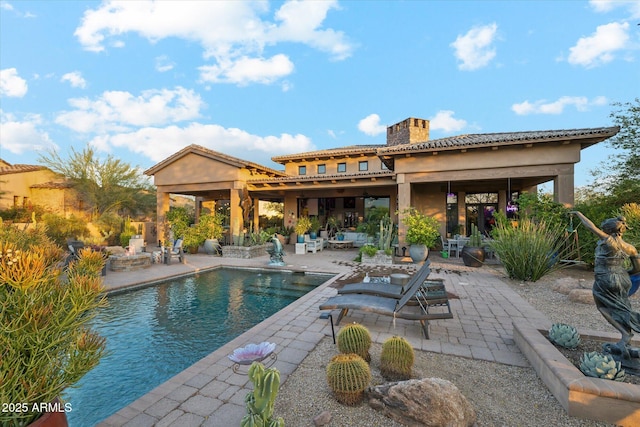 7846 E Wilderness Trl, Gold Canyon, AZ 85118 - rear view of property with a patio area, a chimney, stucco siding, an outdoor living space, and an outdoor pool