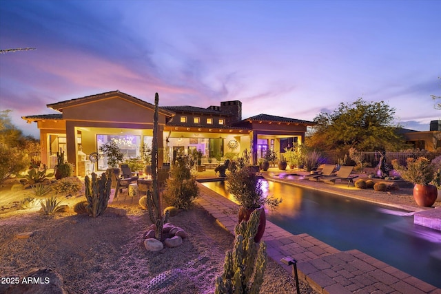7846 E Wilderness Trl, Gold Canyon, AZ 85118 - back of property at dusk with a patio area and stucco siding