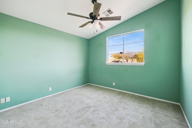 unfurnished room with visible vents, baseboards, ceiling fan, vaulted ceiling, and carpet floors