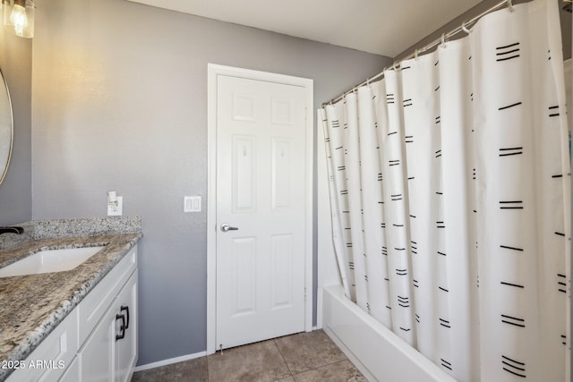 full bathroom with vanity, shower / tub combo with curtain, and baseboards