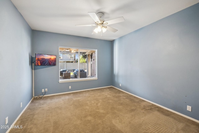 spare room featuring baseboards, carpet floors, and ceiling fan