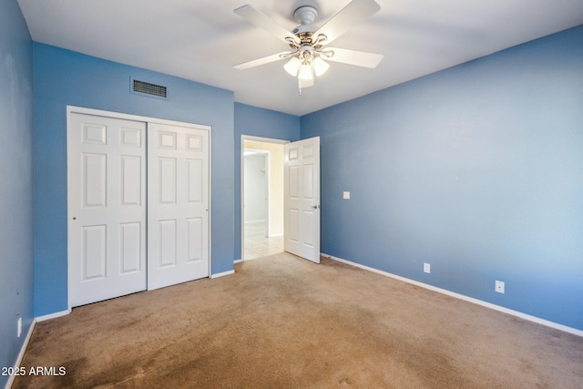 unfurnished bedroom with visible vents, baseboards, carpet flooring, a closet, and a ceiling fan