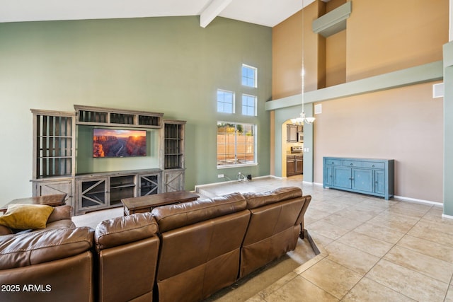 living area with beam ceiling, light tile patterned floors, high vaulted ceiling, and baseboards