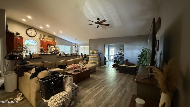 living room featuring lofted ceiling, recessed lighting, dark wood finished floors, and ceiling fan with notable chandelier