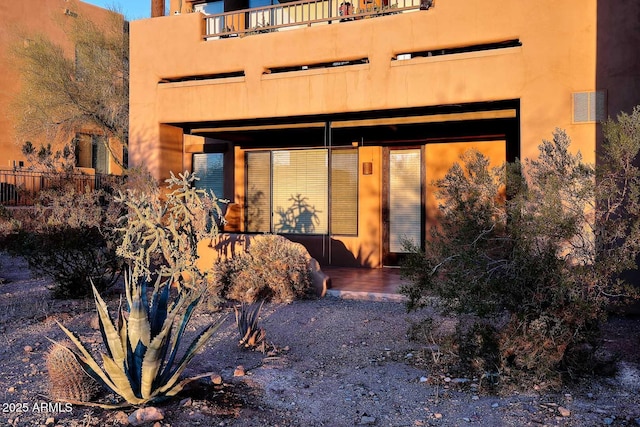 rear view of property with a balcony