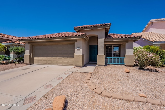 mediterranean / spanish-style house with concrete driveway, stucco siding, an attached garage, and a tiled roof